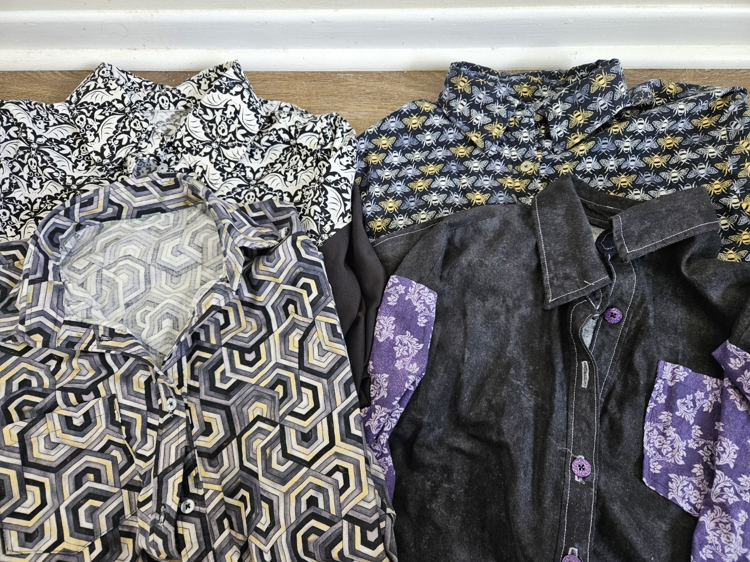 Four button-down shirts made from custom cloth.